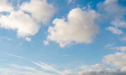 white cirrus, feathery clouds against spring bright blue cloudy sky on sunny day in England