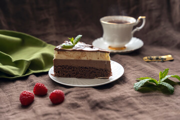 chocolate cake on white plate and tea with strawberry