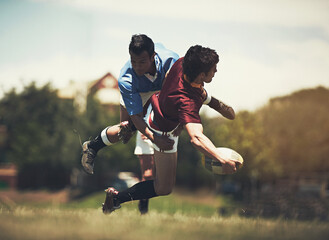 Rugby, tackle and fitness men on a field for sports, ball or action, game or power outdoor. Jump, handball and male team at a park for competitive, training or energy, workout or active challenge