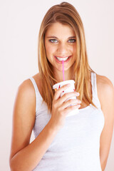 Woman, portrait and drink cup of soda, fizzy cola and ice cold milkshake in studio on white background. Thirsty, happy and young girl sip on straw for takeaway smoothie, juice and fast food beverage