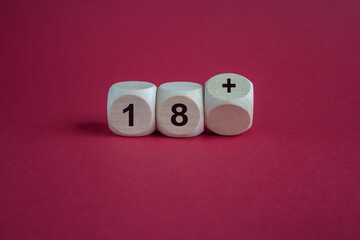 Dice form the expression 18 plus . Symbol for a age restriction. Beautiful red background. Copy space.