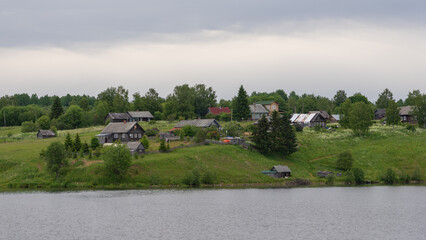 Life of the Russian North, old dilapidated houses along the coast of the Svir River