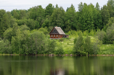 Fototapeta na wymiar Life of the Russian North, old dilapidated houses along the coast of the Svir River