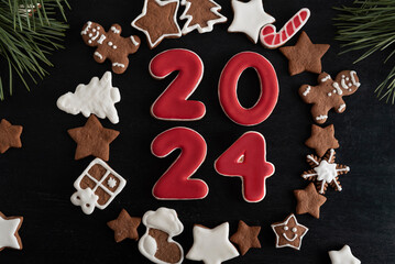 2024 from ginger biscuits glazed sugar icing. Christmas cookies stars, fir-tree and other