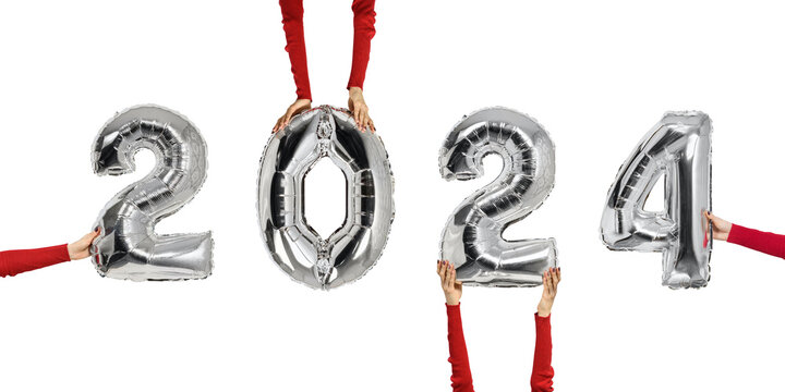 2024 Number of shiny balloons. Figures in female hands. Isolate on white background. New years concept
