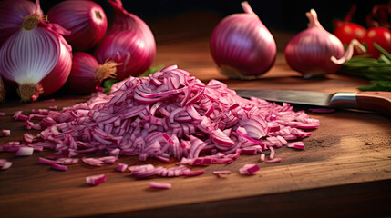 chopped red onions on a board with knife