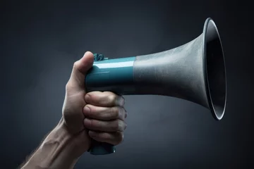 Fotobehang Hand holding megaphone Announcement concept promotion and advertising concept © PinkiePie
