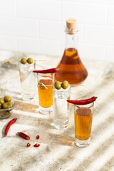 Tequila shots, vodka, whisky, rum. Red chilli pepper. 