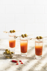 Alcoholic drink bloody mary. A glass, an olive on a skewer. Alcohol shot.