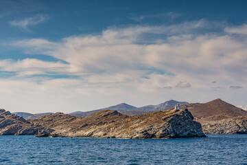 Coastal view with the Korakas lighthouse on the cliff, Paros island GR