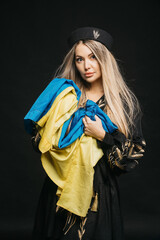 Interior portrait of a young girl with a blue and yellow Ukrainian flag. Ukrainian patriotism...