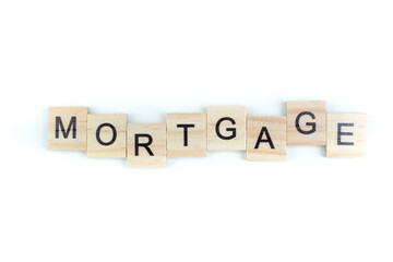 MORTGAGE- word composed fromwooden blocks letters on black background, copy space for ad text.