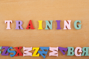 TRAINING word on wooden background composed from colorful abc alphabet block wooden letters, copy space for ad text. Learning english concept.
