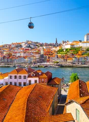 Schilderijen op glas Panoramic view of the city of Porto on a beautiful summer day. Porto, Portugal © proslgn