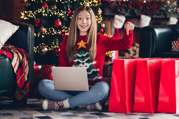 Photo of funky girl teenager brown hair point finger direct finger showing how many bargain gifts she order at black friday for new year