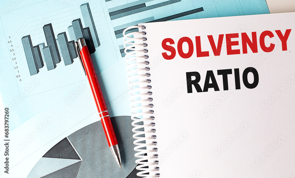 Poster solvency ratio text on a notebook with pen on a chart background