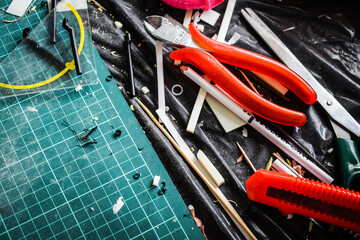 Creative workplace: Materials for scale model building, model assembly, creative work. Building miniatures and decor. Relaxing at home, making your own little world.