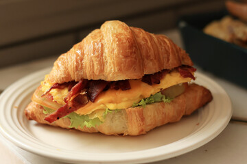 Croissant Sandwich with Cheese, Egg, Ham, Tomato and Lettuce