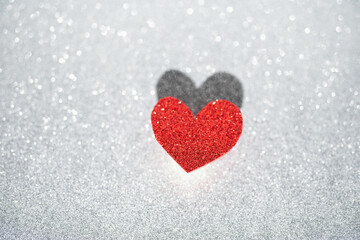 Red heart on a silver background with beautiful bokeh. Valentine's Day is the feast of lovers.