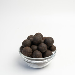 Dried lime in a glass dish on a white background