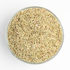Dry organic Aniseeds in a glass dish on a white background