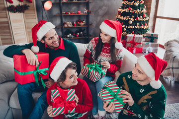 Photo of group friendly funky people sitting sofa exchange unpack desirable christmas time giftbox flat indoors