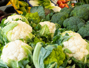 A variety of fresh vegetables displayed at a market in an old town square. Selective focus