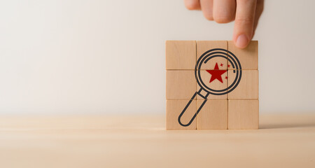 Searching emerging market trends and new opportunities concept. Magnifying glass and stars icons on wooden cube blocks. The potential of emerging markets to drive business growth and profitability.