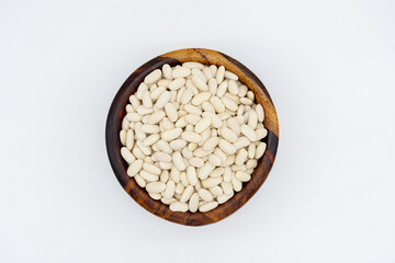 lima beans on a wooden plate isolated on a white background