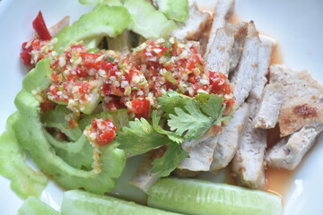 grilled pork slice dressing with lime garlic and chili sauce salad on plate
