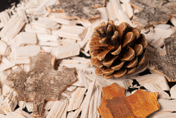Black background with fir or pine cone and white stones