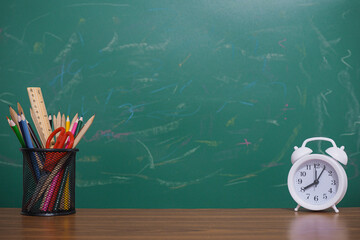 Student creative desktop with colorful stationery and white alarm. Copy space for text, Back to...