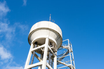 Water tower against a bright blue sky