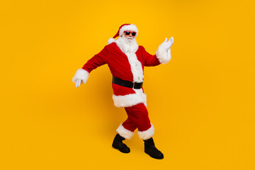 Full body photo of charismatic crazy santa dancing enjoy new year clubbing isolated on yellow color...