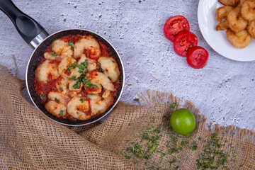 Seafood made with golden prawns dipped in red tomato sauce
