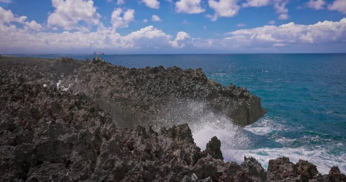 Slow motion of large waves crashing against the rocks of the coastline. Waterblow on Bali's Nusa Dua island. Footage of beautiful powerful waves of the Indian Ocean, beautifully crashing the rocks.