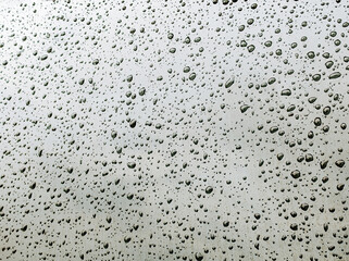 Water or raindrops on a black glass. Abstract texture background.