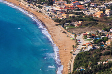 The sandy beach of Agios Georgios on the island of Corfu on a stormy day with high waves