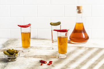 Tequila shots, vodka, whisky, rum. Red chilli pepper. 