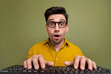 Photo of excited nice man coder administrator wear yellow stylish clothes hands touch keypad buttons isolated on khaki color background