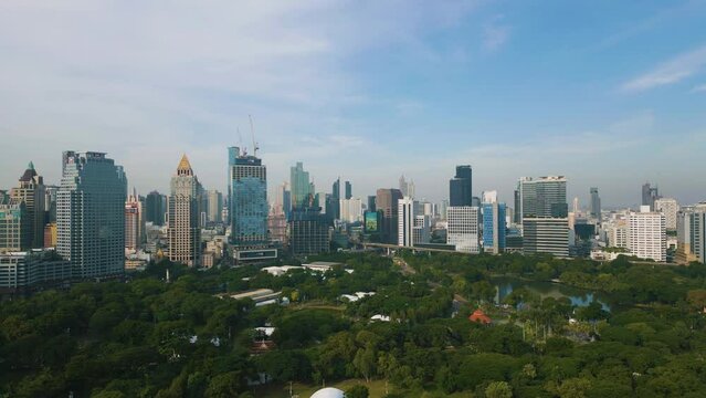 Aerial view city office building with green park Lumpini morning sunrise Bangkok Thailand