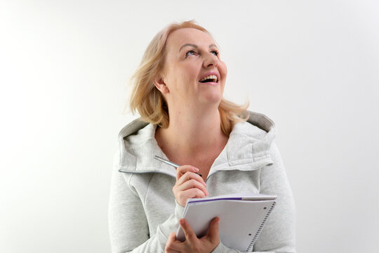 fat girl blonde holds a white sheet Bright picture of smiling woman face with hand her hear. High quality photo