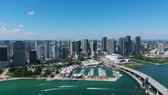 Drone view of fantastic large Miami city overlooking bay marina with various yachts and boats. Nice road bridge over turquoise water in one of gorgeous resort of USA