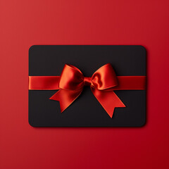 Blank black gift card with red ribbon bow isolated on red background