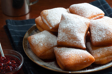 New Orleans Style Beignets, Fried Dough Fritters Topped with Powdered Sugar and Raspberry Sauce