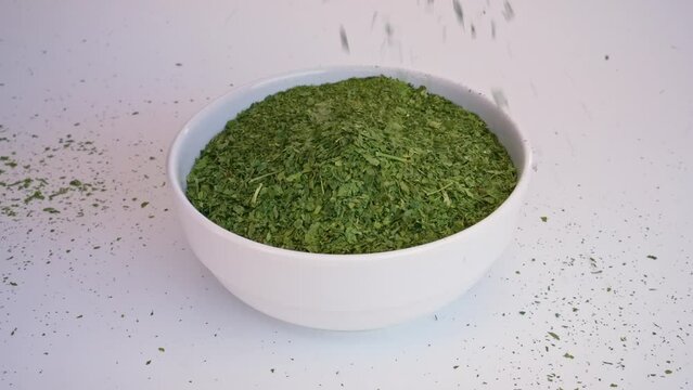 corchorus olitorius or Molokhia falling in a white plate on a white background