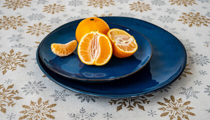 Tangerines on a blue ceramic plate, closeup
