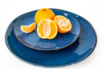 Tangerines on a blue ceramic plate, closeup