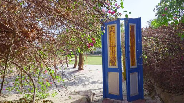 An antique door in an outdoor public garden helps calm and relax