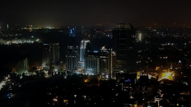 Aerial shot of high-rise skyscrapers at night with illuminated lights flashing in Bangalore